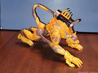 Cheetor figure in cheetah mode, side view showing yellow body and metallic detailing