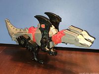 Left side view of Doublecross in dragon mode showing color scheme and articulation