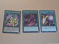 Front view of all three cards: Magnet Induction, Dwimmered Path, Hyper Galaxy