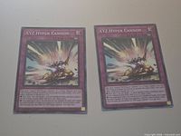 Front view of both XYZ Hyper Cannon cards side by side