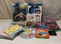 Group shot of all craft items including kits, beads, cards, stamp pad, stamps