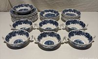 Overall grouping showing stacks of plates and front row of handled bowls