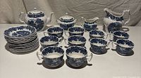 Full set showing teapot, sugar, pitcher, creamer, stack of plates and cups