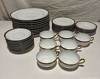 Full set stacked showing plates, bowls, cups and saucers