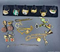 All items laid out, showing rings on holder and other jewelry pieces