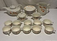 Full set showing teapot, sugar bowl, pitcher, cups and saucers