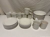 Full set laid out: stacks of cups, saucers, plates, bowls