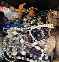 Pile of assorted necklaces and bracelets in various bead styles and colors