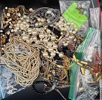 Mixed costume jewellery spread with faux pearls, wood beads, chains and bagged items