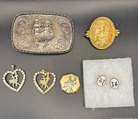 Front view of all jewelry pieces showing motifs and finishes