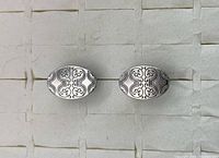 Front view of both cufflinks showing engraved design