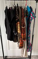 Full rack view of nine garments hanging together