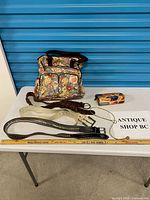 All items laid out: four belts, floral tote, decorative box