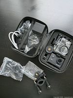 Open case showing camera, waterproof housing, mounts, cable