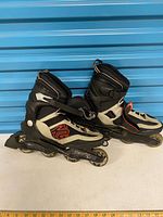 Full side view of both skates showing overall design and wear