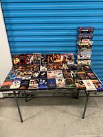 Entire lot on table with stacked tapes showing quantity and variety