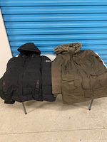 Both jackets front view on table