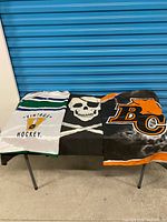 Overview of three folded flags laid on table