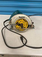 Front view of Makita circular saw with DeWalt blade and power cord visible