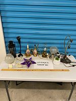 Group shot of all nine lighting items on table with ruler for scale