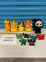 Group shot of all plush toys and gel monster figures