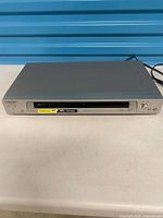 Front and top view of Sony DVP-NS315 player with attached power cord