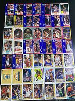 Overview of entire spread of approximately 80 NBA cards from early-mid 1990s showing multiple brands and players