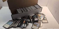 Open 800-count box with Magic cards inside and spread on table to show card variety.
