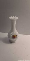 Full view of white hobnail milk glass vase with floral decal