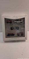 Front of boxed Hallmark Keepsake North Pole Central Train showing five ornaments