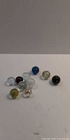All ten marbles grouped on white background