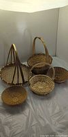 All five wicker baskets grouped to show forms and handles