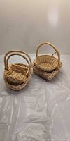 Group of four small wicker baskets