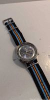 Full view of Seiko SSC667 watch with striped NATO strap