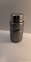 Front view of stainless steel Thermos food jar with lid on