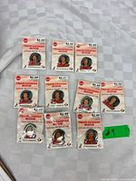 Ten sealed Team Canada 2002 pins laid out on table
