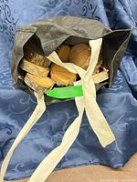 Bag containing visible stack of wooden rounds