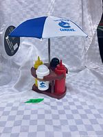 Condiment caddy assembled showing umbrella, base and four bottles