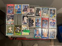 Overview of all 16 cards inside binder page on table