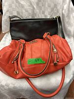 Fiorelli orange satchel and Liz Claiborne black shoulder bag together