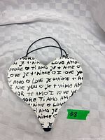 Front view showing heart shape, love script design, and handle placement