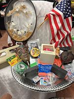 Overview of lot showing shadow box, flag, mask, Super Ball, tray and small packaged items
