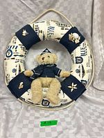 Full view of nautical life-preserver wreath with sailor teddy attached