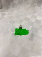 Front view of sterling silver Pandora charm on fabric backdrop