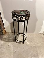 Full view of tall round metal accent table