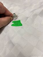 Ring held to show top with blue stones and 925 mark area