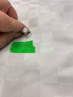 Ring held to show stone and band