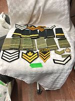 All cloth insignia pieces spread on chair