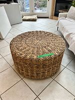 Angled view of entire ottoman showing woven texture and size