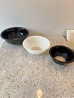 Three glass bowls displayed separately on countertop